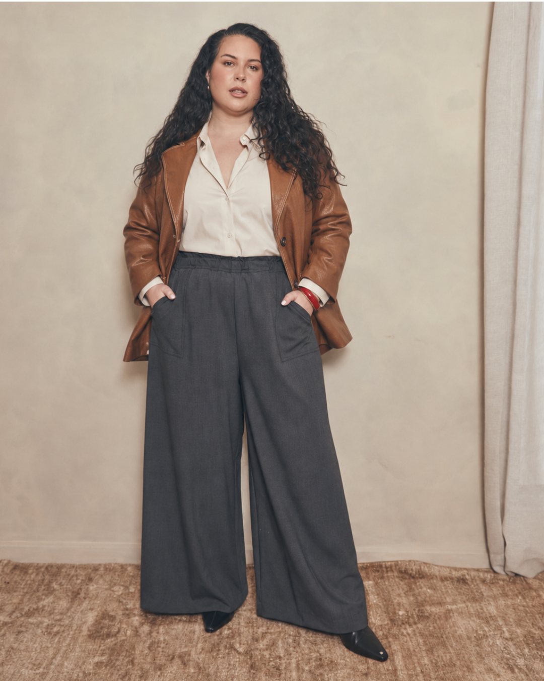 Woman in wide-leg trousers, white shirt and tan leather blazer — Pablo & Kat thoughtful fashion