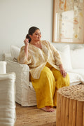Willow Broderie Top in Saffron — seated lifestyle