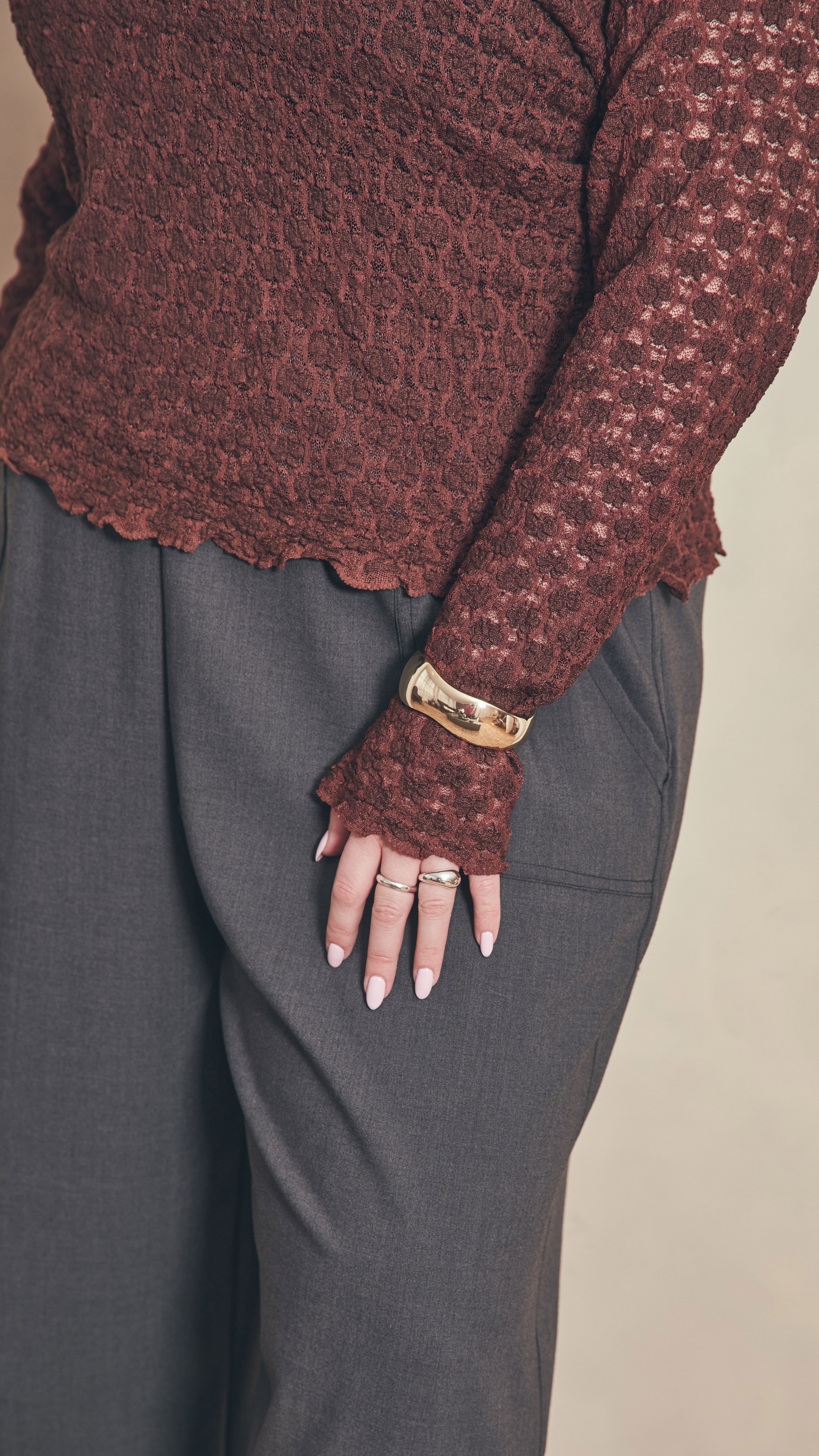 Chocolate lace top has fluted hems on the sleeves and body.