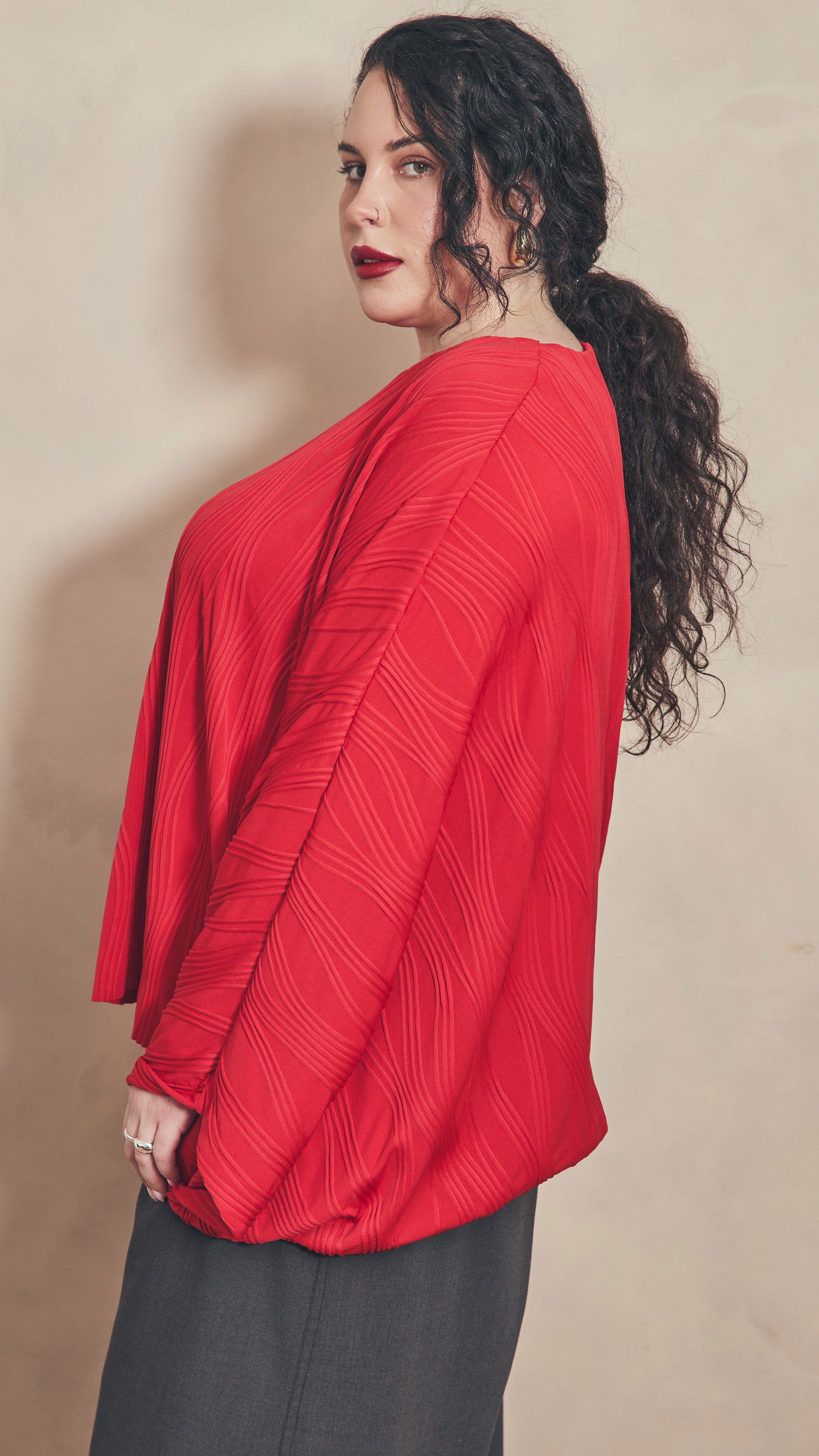 Side view of red dolman top.